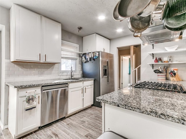 4215 N Barr Ave, Oklahoma City, OK 73122 - kitchen featuring white cabinetry, appliances with stainless steel finishes, light stone countertops, and sink