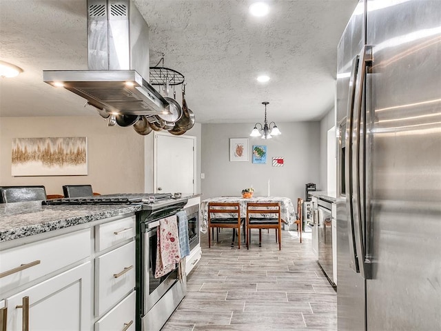 kitchen with decorative light fixtures, white cabinetry, island exhaust hood, stainless steel appliances, and light stone countertops