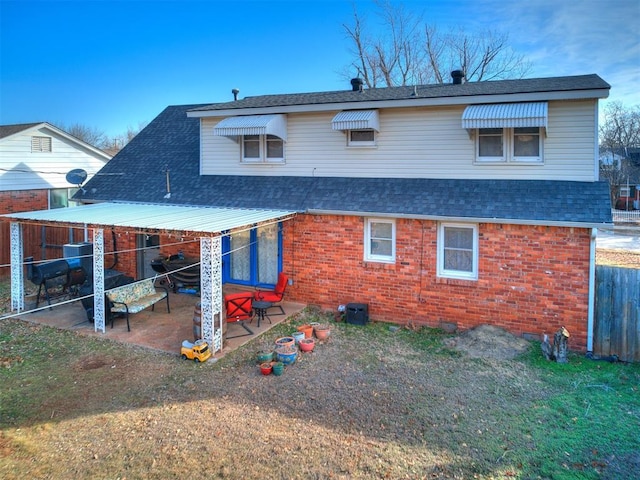 back of property with a patio area and a lawn