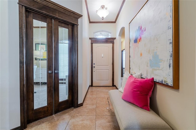 doorway featuring light tile patterned floors, crown molding, and french doors