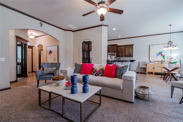 tiled living room featuring ceiling fan with notable chandelier and ornamental molding