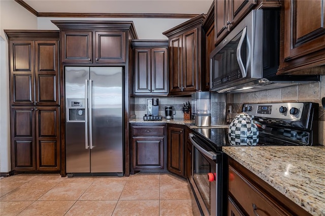 kitchen with light tile patterned floors, dark brown cabinets, stainless steel appliances, light stone countertops, and decorative backsplash