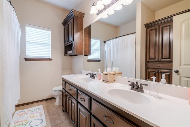 bathroom featuring vanity, toilet, and tile patterned flooring