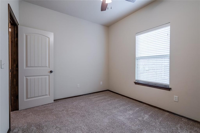 carpeted empty room featuring ceiling fan