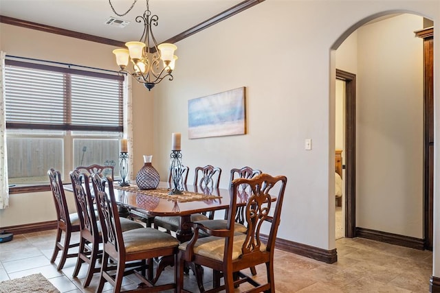 dining space featuring light tile patterned flooring, ornamental molding, and a notable chandelier