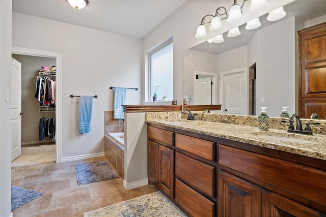 bathroom featuring vanity and a relaxing tiled tub