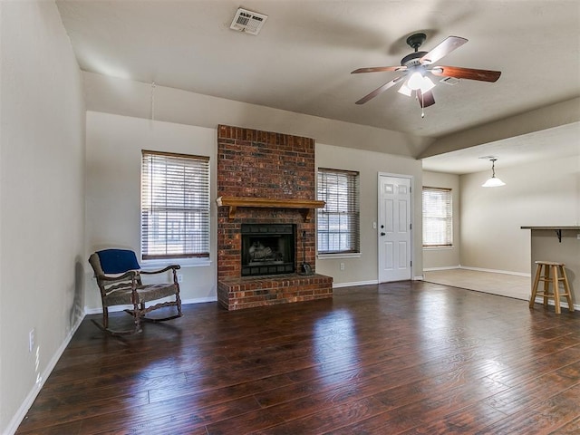 unfurnished living room with dark hardwood / wood-style flooring, a fireplace, and ceiling fan