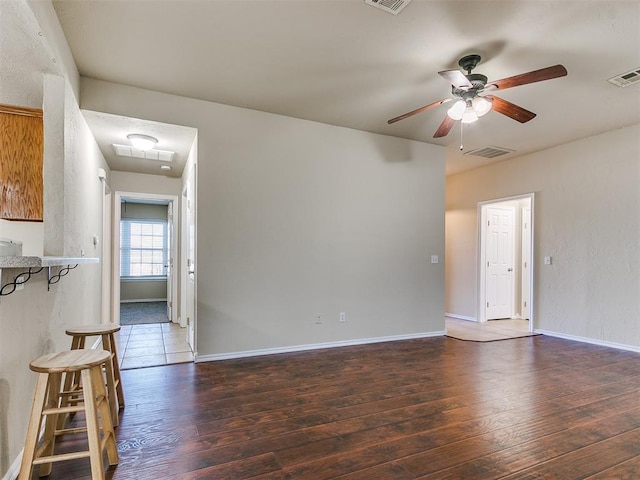 unfurnished living room with ceiling fan and dark hardwood / wood-style floors