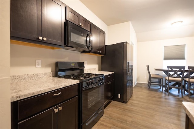 kitchen featuring light hardwood / wood-style floors, dark brown cabinets, and black appliances