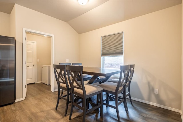 dining area with lofted ceiling and dark hardwood / wood-style flooring