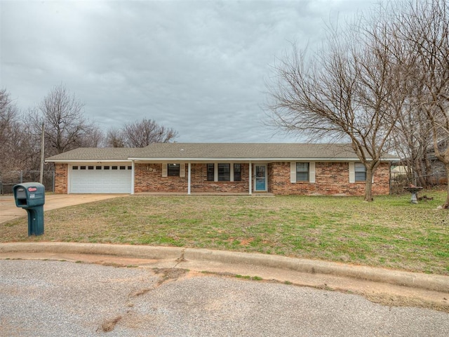 ranch-style house featuring a garage and a front lawn