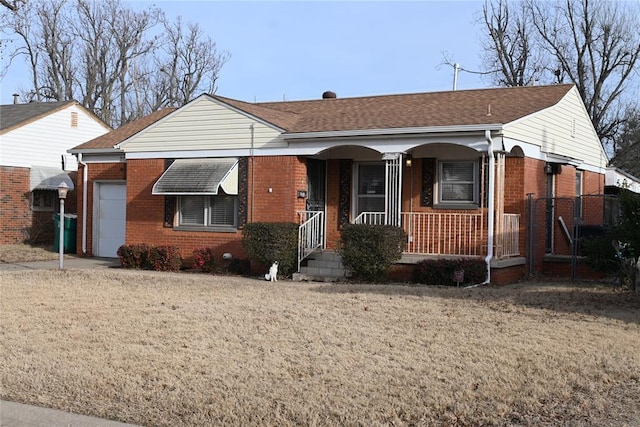 ranch-style house with a garage, a front yard, and covered porch