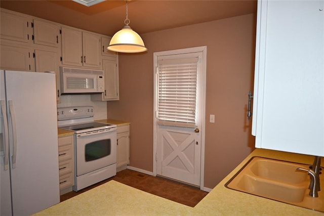 kitchen featuring sink, white cabinets, white appliances, and decorative light fixtures