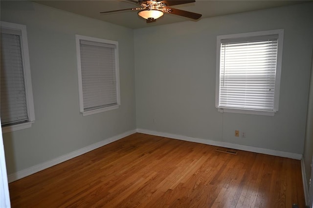 empty room featuring hardwood / wood-style floors and ceiling fan