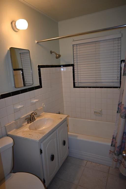 full bathroom with tile walls, tile patterned flooring, vanity, toilet, and shower / bath combo