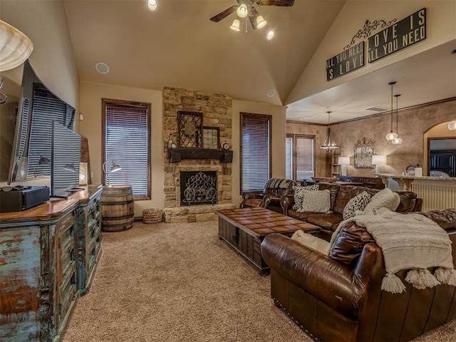 carpeted living room with a fireplace, high vaulted ceiling, and ceiling fan