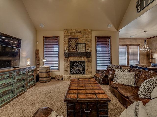 carpeted living room with a stone fireplace and vaulted ceiling