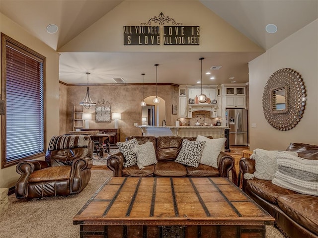 living room with vaulted ceiling and carpet