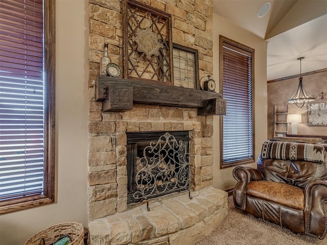 living area with a fireplace, vaulted ceiling, and carpet