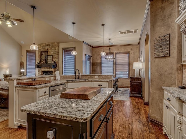 kitchen with dishwasher, a center island, sink, and dark wood-type flooring