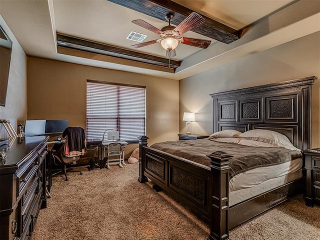 bedroom with a raised ceiling, carpet, and ceiling fan