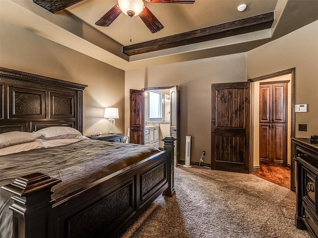 carpeted bedroom with ceiling fan, connected bathroom, and a tray ceiling