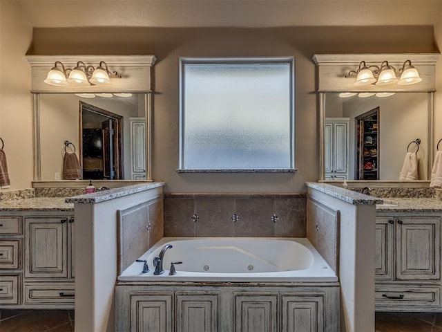 bathroom featuring tile patterned floors, vanity, and a bathing tub