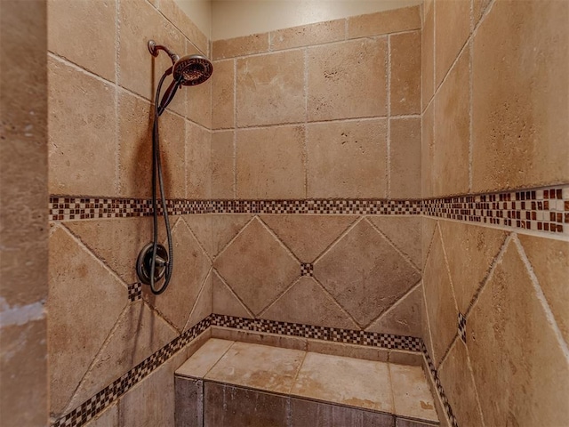 interior details featuring tiled shower