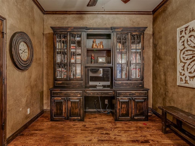 interior space featuring ceiling fan, ornamental molding, dark brown cabinetry, and dark hardwood / wood-style flooring