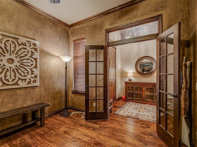 doorway to outside featuring crown molding and dark hardwood / wood-style flooring