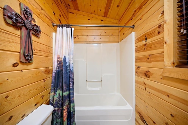 bathroom with wood walls, lofted ceiling, shower / tub combo, wood ceiling, and toilet