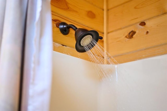 interior details featuring a shower with shower curtain