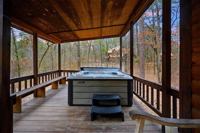 wooden terrace featuring a hot tub