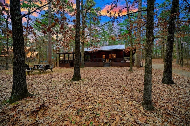 yard at dusk featuring a wooden deck