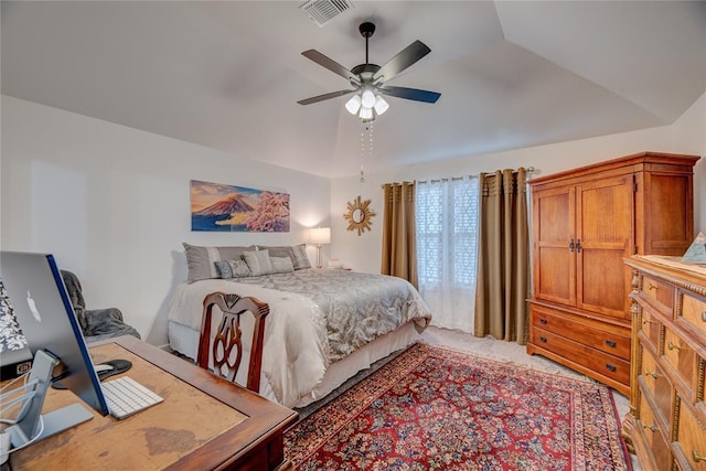 bedroom with ceiling fan, light colored carpet, and vaulted ceiling