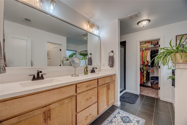 bathroom featuring vanity, tile patterned floors, and walk in shower