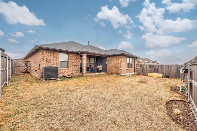 back of property featuring a yard and central AC unit