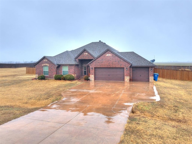 view of front of house with a garage and a front yard