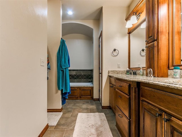 bathroom featuring vanity and a bath