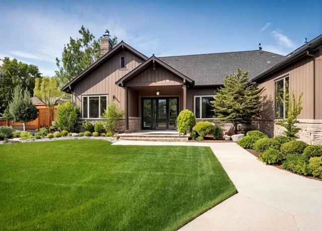 back of house featuring a yard and french doors