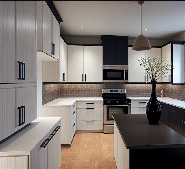 kitchen featuring decorative backsplash, appliances with stainless steel finishes, a kitchen island, and hanging light fixtures