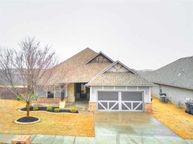 view of front of property with cooling unit, a garage, and a front yard