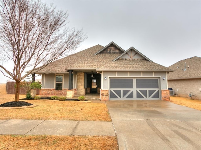 craftsman-style home with cooling unit and a garage