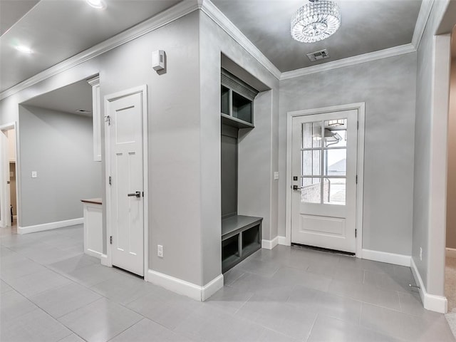 mudroom featuring ornamental molding and light tile patterned floors