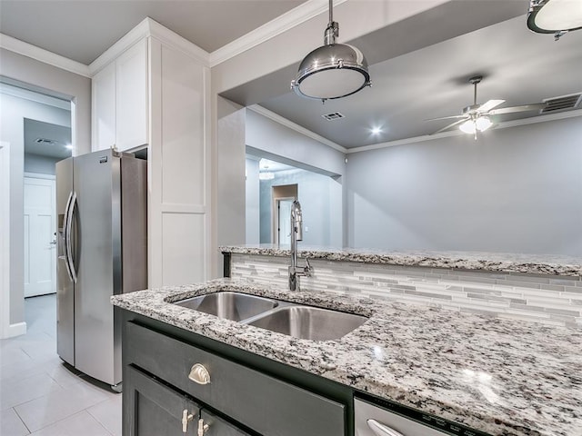 kitchen featuring white cabinetry, appliances with stainless steel finishes, sink, and ornamental molding