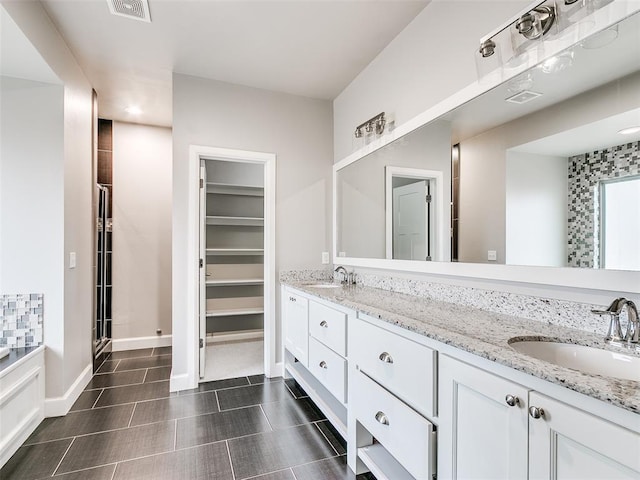 bathroom with independent shower and bath and vanity