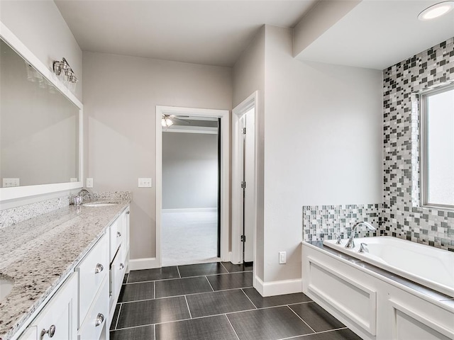 bathroom featuring vanity and a washtub