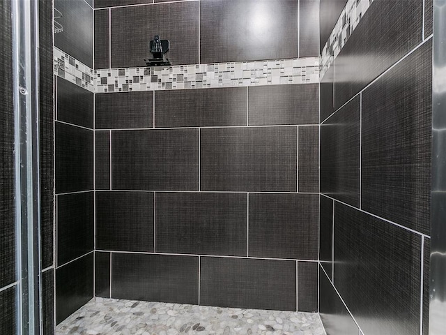 bathroom with a tile shower