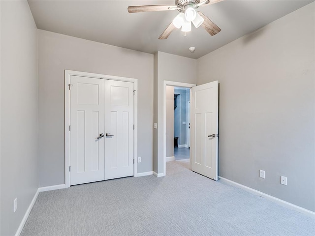 unfurnished bedroom with light carpet, ceiling fan, and a closet