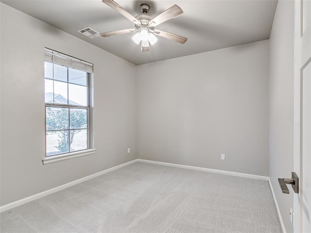 carpeted spare room featuring ceiling fan